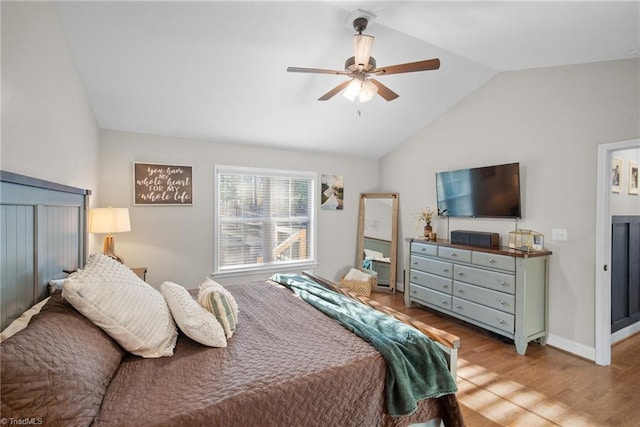 bedroom featuring lofted ceiling, wood finished floors, a ceiling fan, and baseboards