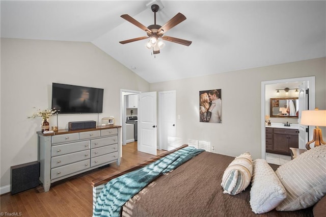 bedroom with connected bathroom, a ceiling fan, lofted ceiling, light wood-style flooring, and a sink