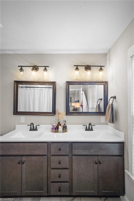 full bathroom with double vanity and a sink