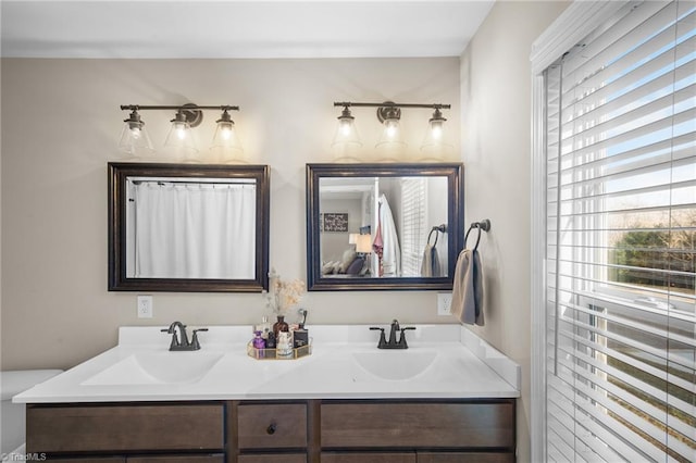 full bathroom with a sink and double vanity