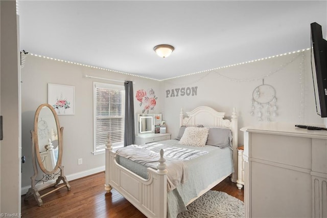 bedroom featuring dark wood-style floors and baseboards