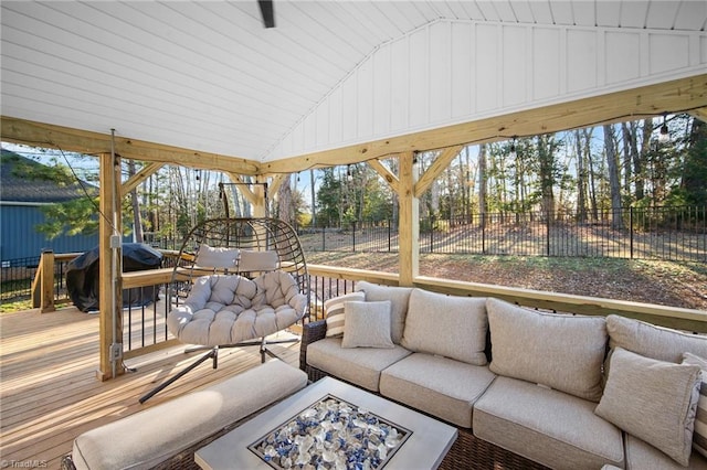 exterior space with fence, a deck, and an outdoor living space with a fire pit