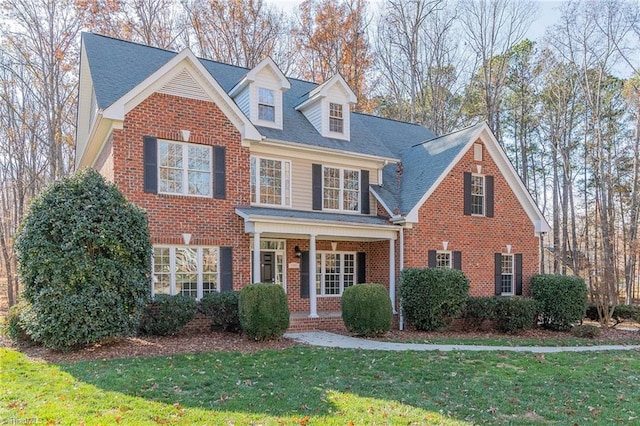 view of front of home featuring a front yard and a porch