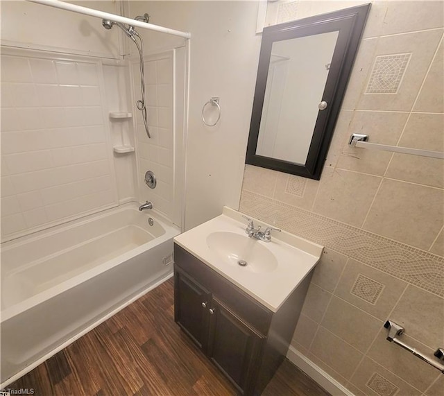 bathroom with tub / shower combination, vanity, and wood finished floors