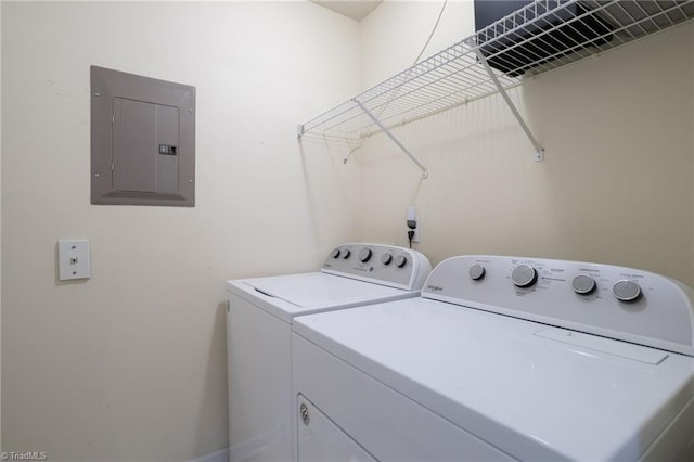 washroom with electric panel and washing machine and clothes dryer