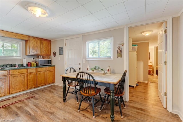 dining room with light wood-style flooring and baseboards