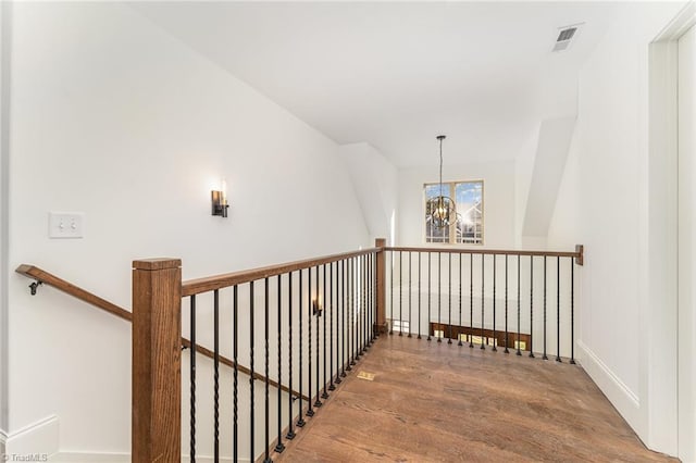 8812 Rudy Dr, Kernersville, NC 27284 - staircase featuring wood finished floors, a chandelier, and baseboards