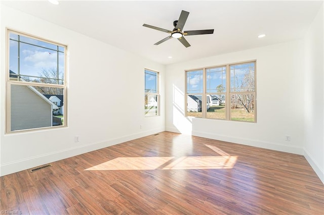 empty room featuring hardwood / wood-style flooring and ceiling fan