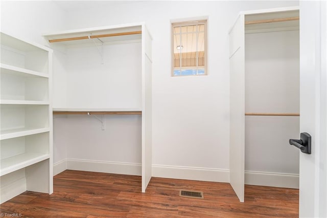 walk in closet featuring dark wood-type flooring