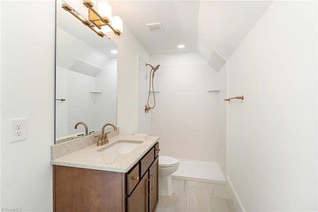 bathroom with toilet, vanity, lofted ceiling, and a tile shower