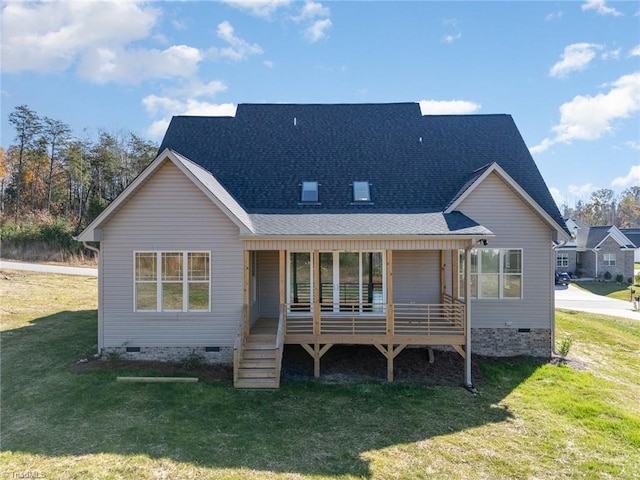 rear view of house with covered porch and a lawn