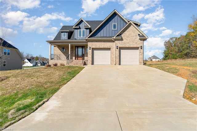 view of front of home featuring a front lawn, a garage, and a porch