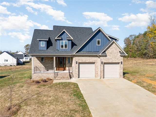 view of front facade with a porch, a front yard, and a garage