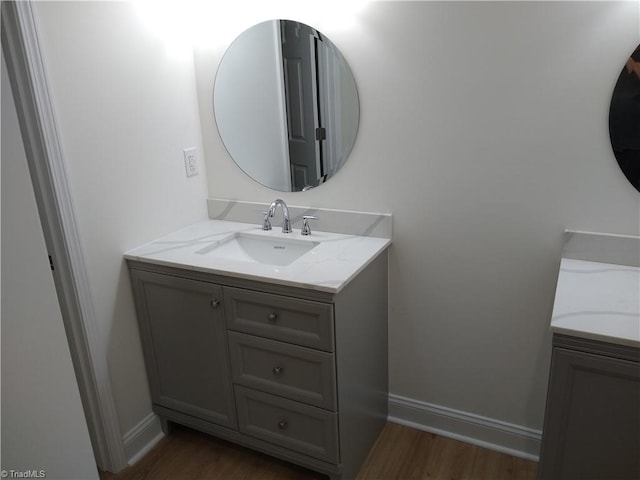 bathroom with hardwood / wood-style floors and vanity