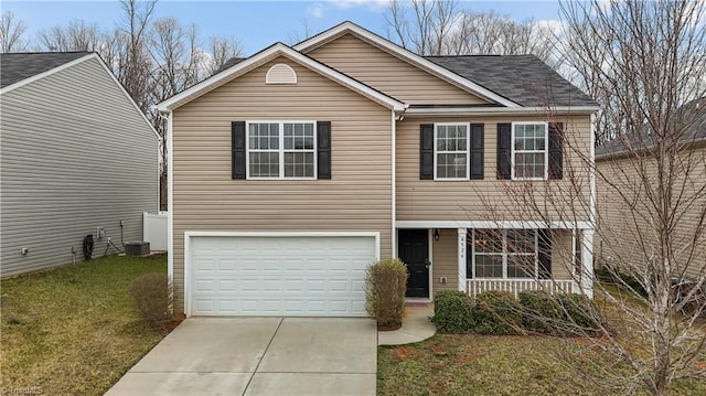 traditional home featuring concrete driveway, a garage, and a front lawn