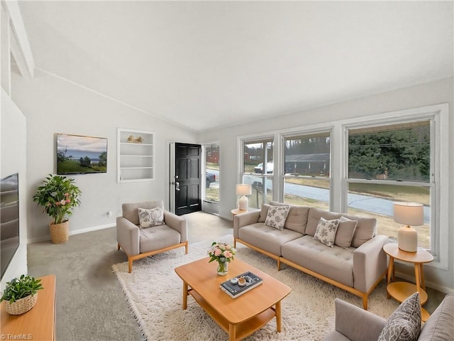 living room featuring lofted ceiling, light colored carpet, and baseboards