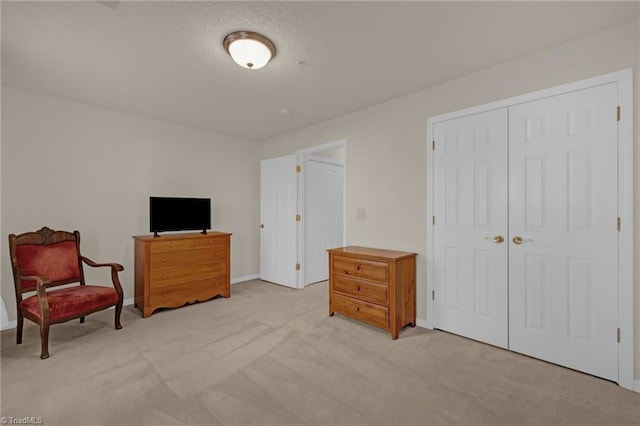 interior space featuring a textured ceiling and light carpet