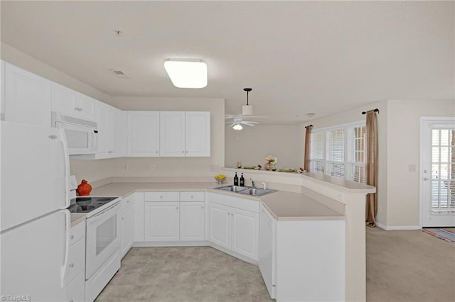 kitchen with white appliances, white cabinets, sink, ceiling fan, and kitchen peninsula