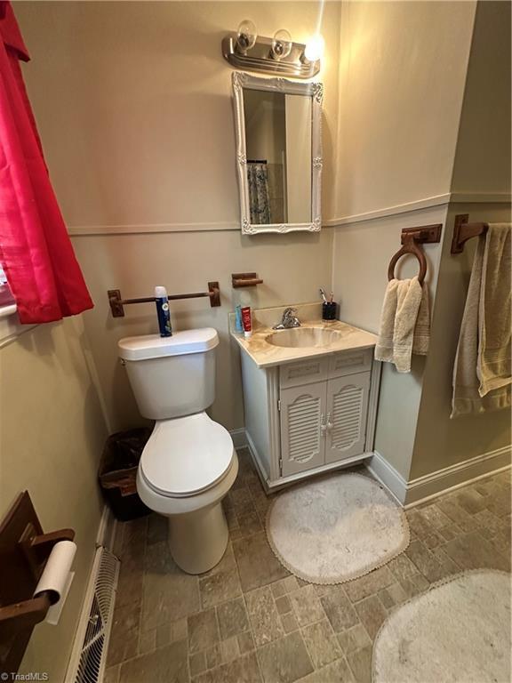 735 Fairfield St, Burlington, NC 27215 - bathroom featuring toilet, vanity, and baseboards