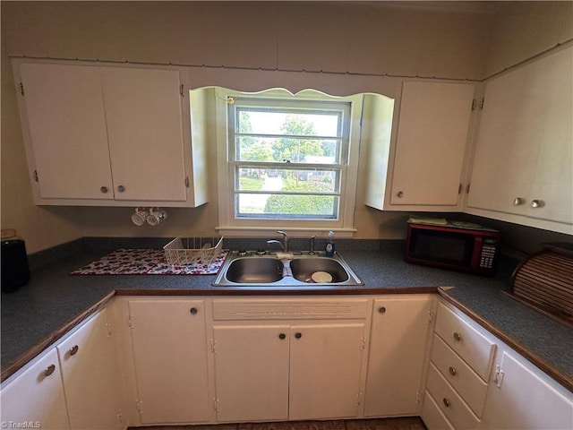 735 Fairfield St, Burlington, NC 27215 - kitchen featuring a sink, white cabinetry, and dark countertops