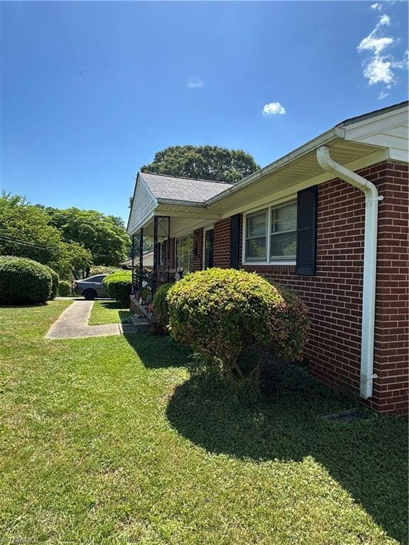735 Fairfield St, Burlington, NC 27215 - view of side of property featuring brick siding and a lawn