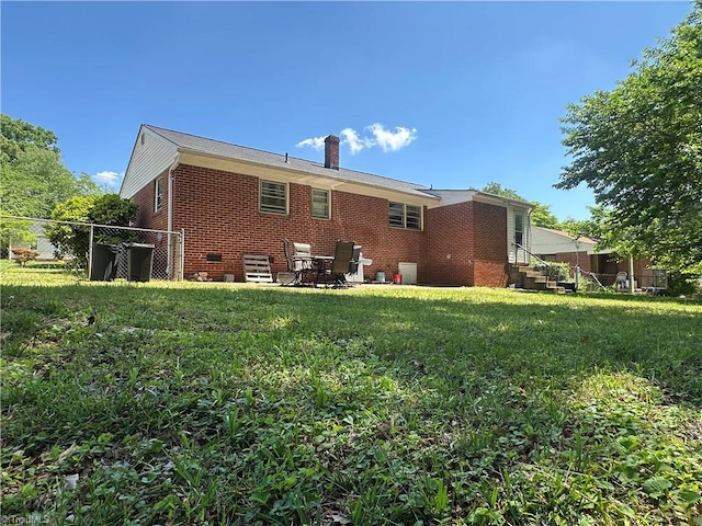 735 Fairfield St, Burlington, NC 27215 - back of property featuring brick siding and a chimney