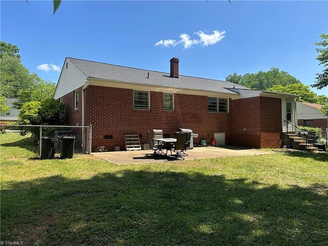 735 Fairfield St, Burlington, NC 27215 - back of property featuring brick siding, a chimney, entry steps, and a patio