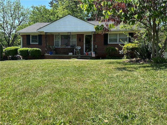 735 Fairfield St, Burlington, NC 27215 - view of front of house with a porch, a front lawn, and brick siding