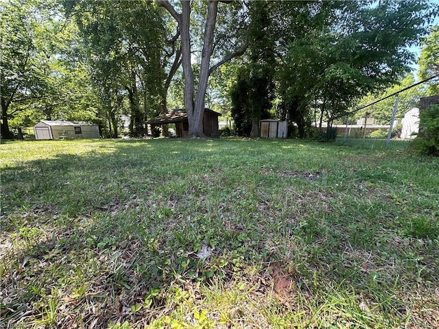735 Fairfield St, Burlington, NC 27215 - view of yard featuring a storage unit and an outbuilding