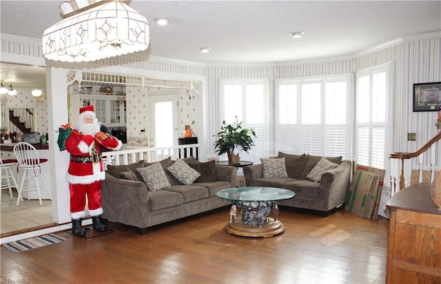 living room with hardwood / wood-style flooring, plenty of natural light, and crown molding