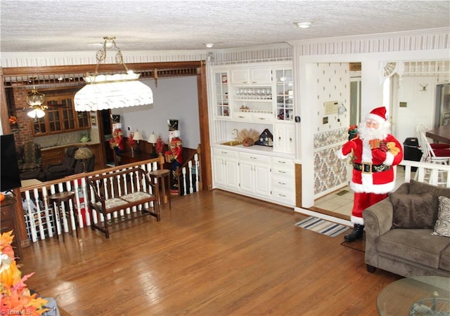 dining area with dark hardwood / wood-style flooring, ornamental molding, and a textured ceiling