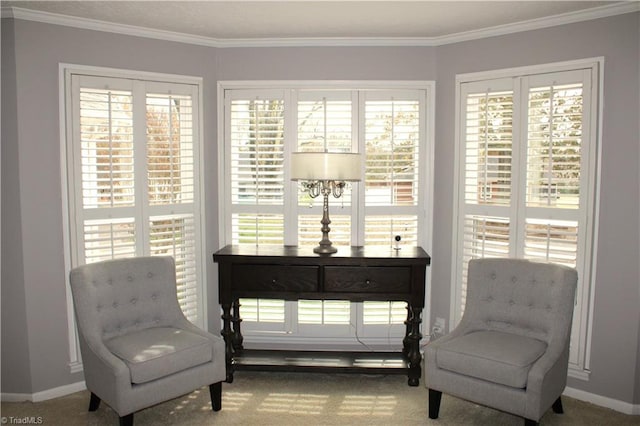 sitting room featuring carpet flooring, crown molding, and a healthy amount of sunlight