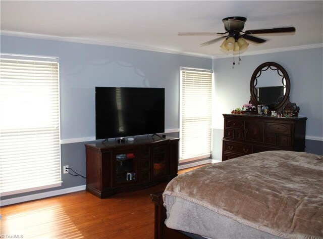 bedroom with ceiling fan, light hardwood / wood-style flooring, and ornamental molding