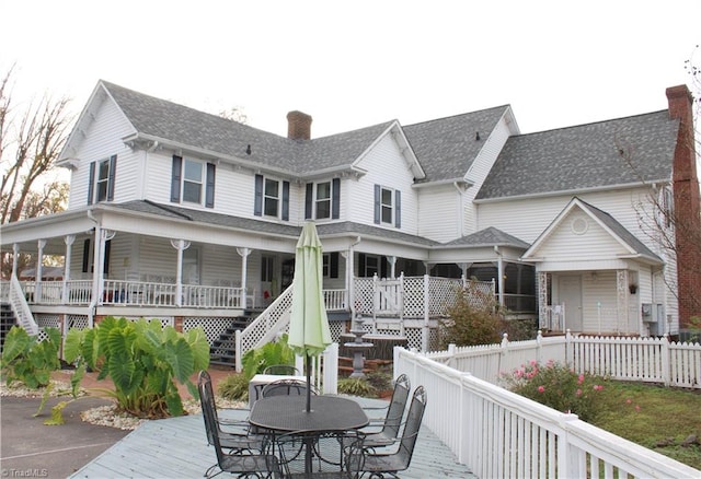 back of property featuring a wooden deck