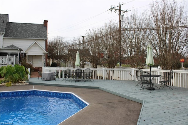 view of swimming pool with a wooden deck