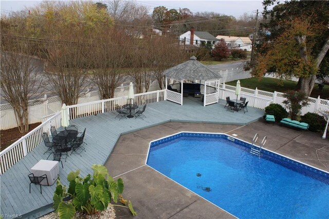 view of pool with a gazebo and a wooden deck