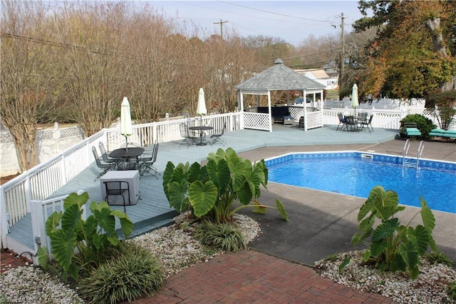 view of swimming pool featuring a gazebo and a deck