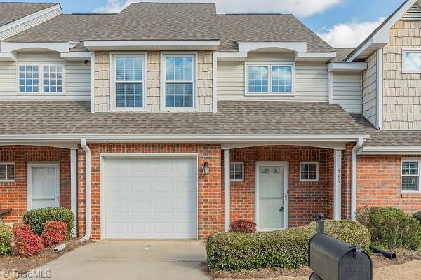 townhome / multi-family property featuring a garage