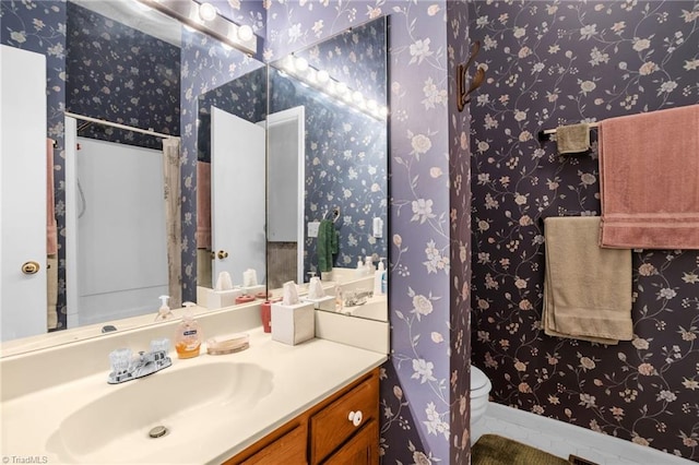 bathroom featuring vanity, toilet, and tile patterned floors