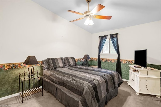 carpeted bedroom with a ceiling fan, baseboards, and vaulted ceiling