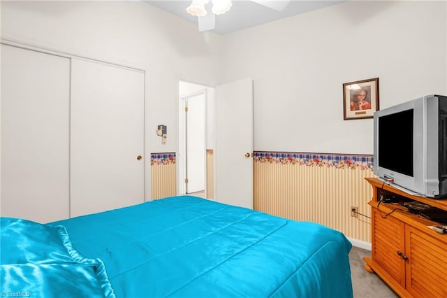 carpeted bedroom featuring a closet and a ceiling fan