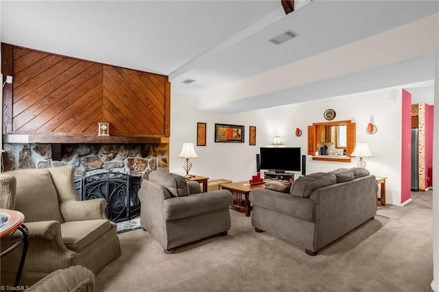 living area with a fireplace, light colored carpet, and visible vents