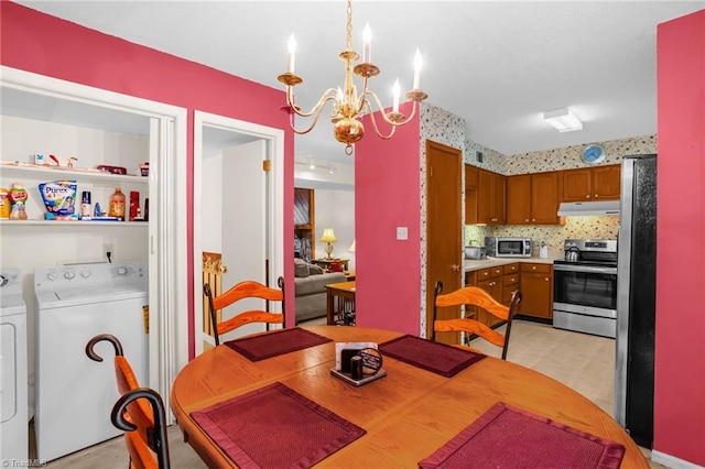 dining area with separate washer and dryer and an inviting chandelier