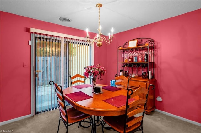 dining area with visible vents, carpet, baseboards, and a chandelier