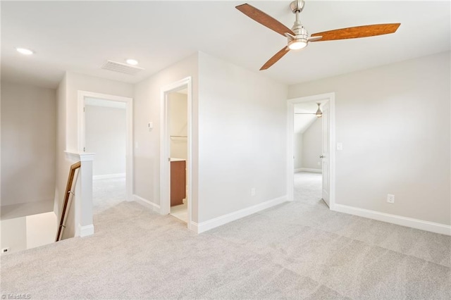 carpeted spare room with ceiling fan