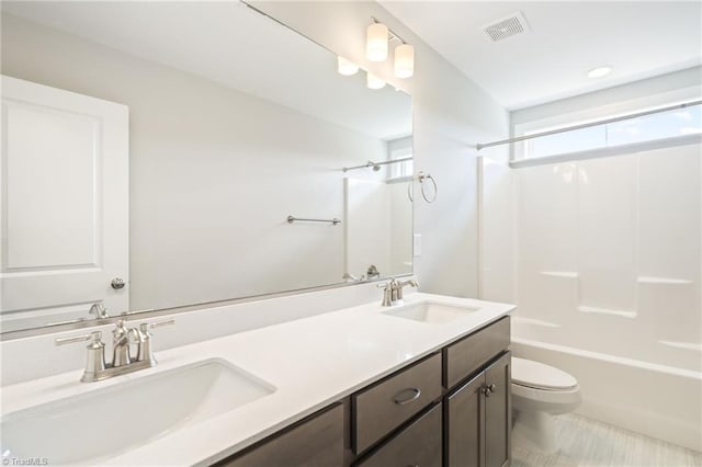 full bathroom with vanity, shower / bathtub combination, and toilet