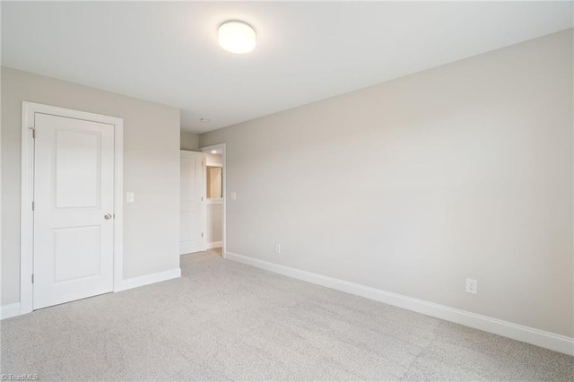 unfurnished bedroom featuring carpet floors and a closet