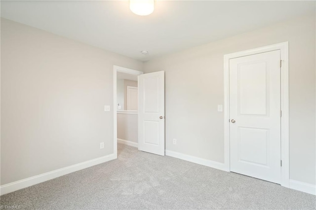 unfurnished room with light colored carpet