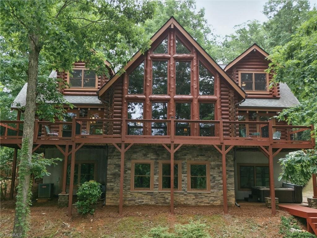 559 Dockside Ter, Denton, NC 27239 - rear view of house featuring outdoor lounge area, stone siding, central AC unit, and log siding