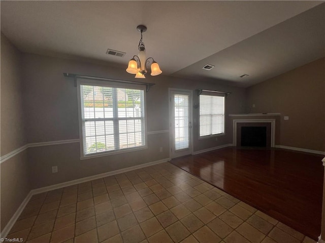 111 Braewyck Ln, King, NC 27021 - unfurnished living room with a chandelier, a fireplace, lofted ceiling, and tile patterned flooring